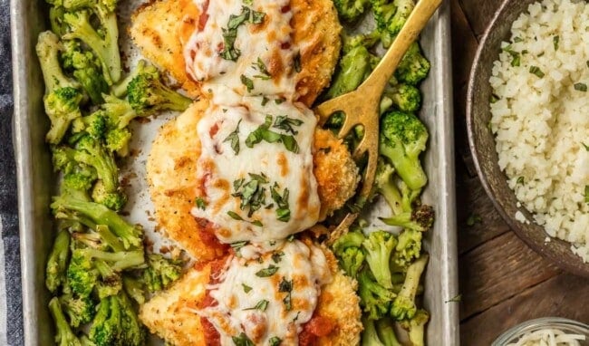 This amazing SHEET PAN CHICKEN PARMESAN with roasted broccoli and riced cauliflower is SO easy and an instant family favorite. Healthy Baked Chicken Parmesan topped with marinara, melty mozzarella, and fresh basil...what could be better?