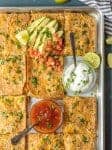 This Chicken Quesadilla Recipe for a crown is made on a sheet pan! Sheet Pan Chicken Quesadillas are the easiest and best way to make delicious quesadillas for a crowd! These baked chicken quesadillas can be made with any filling and toppings, and are sure to please even the pickiest eaters. If you've wondered How to Make Chicken Quesadillas, this recipe is for you!
