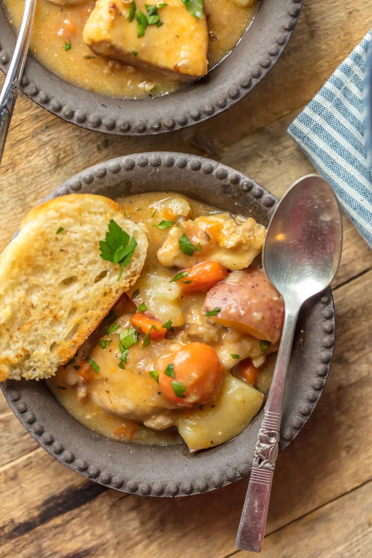 A bowl of white wine chicken stew with bread