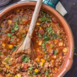 beef tortilla soup in a bowl with wooden spoon