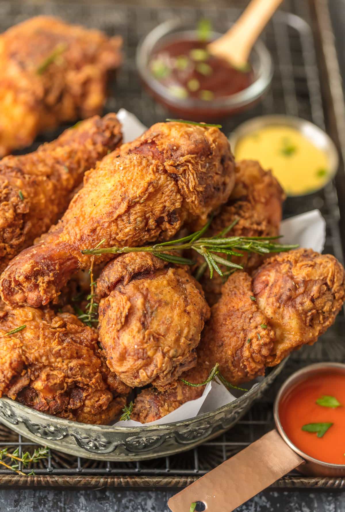 up close picture of fried chicken drumstick in serving bowl