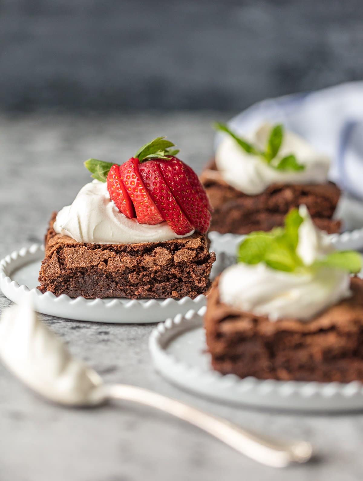 homemade brownies with whipped cream and strawberries