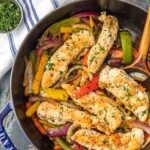 cilantro chicken stir fry in a skillet with a wooden spoon