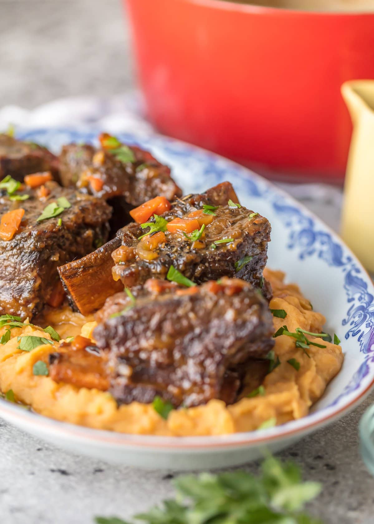 A plate of mashed sweet potatoes and honey bourbon short ribs