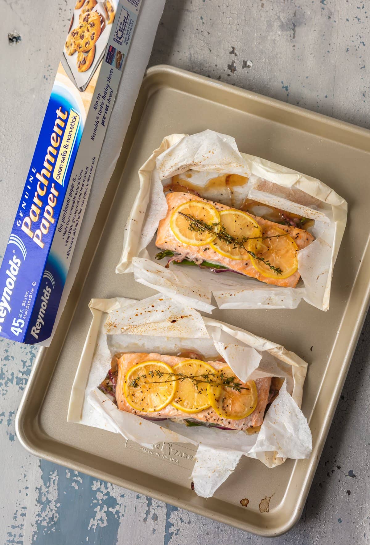 parchment paper packets with salmon on a baking sheet