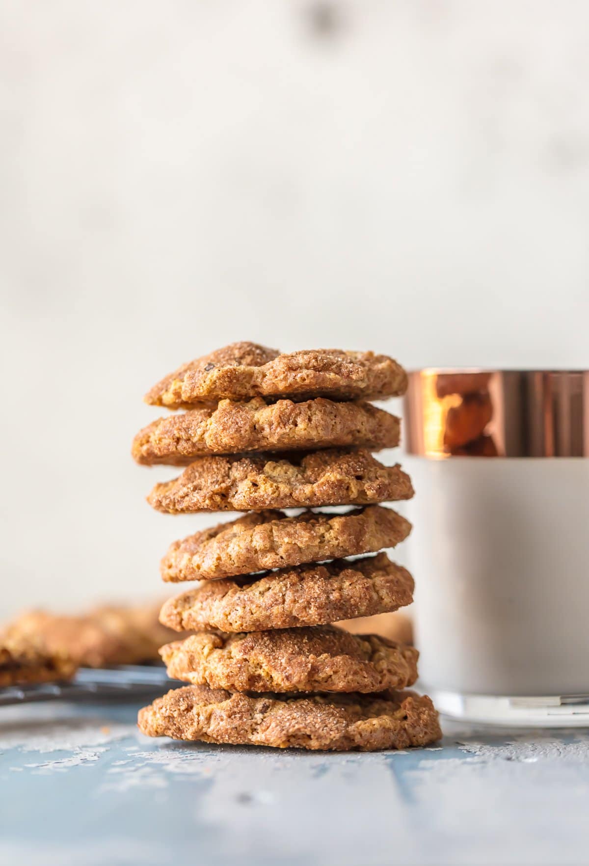 A stack of the best oatmeal chocolate chip cookies next to a glass of milk