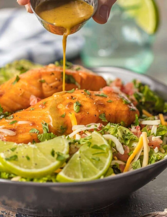 This TEQUILA LIME SALMON SALAD is the perfect hearty and delicious salad for any occasion! Salmon topped with a spicy tequila lime marinade and laid atop a bed of lettuce, corn, beans, avocado, pico, and more! SO MUCH FLAVOR!