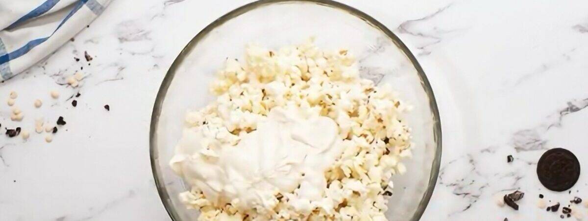 Popcorn with melted white chocolate chips on it. 