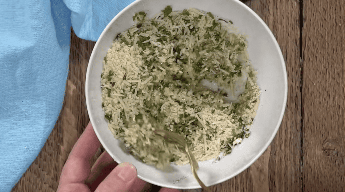 seasoned breadcrumbs with parmesan cheese mixed with butter in a bowl.