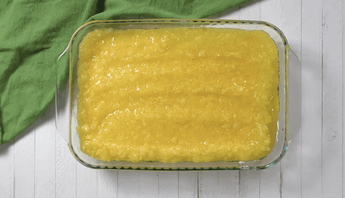 Crushed pineapple and Jello mixture on top of the whipped topping. 