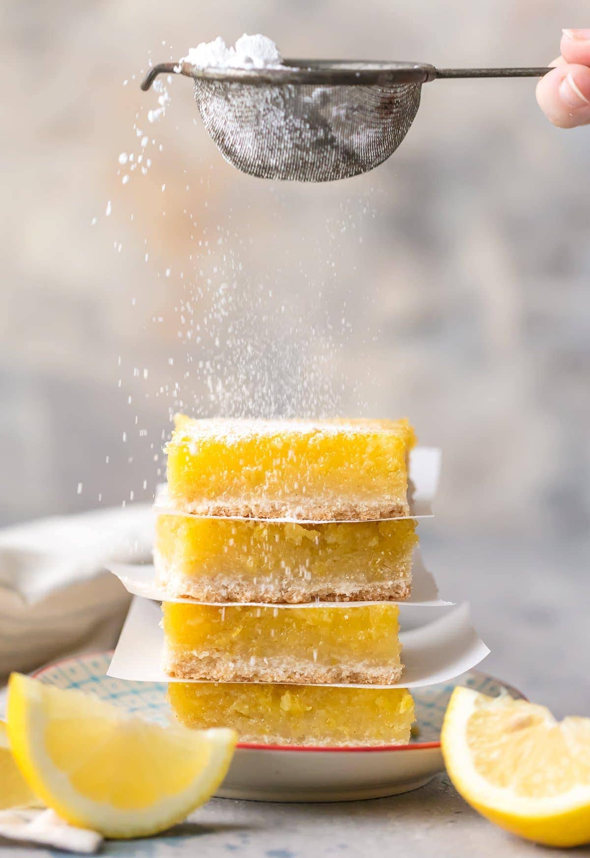 lemon squares stacks and garnished with powdered sugar