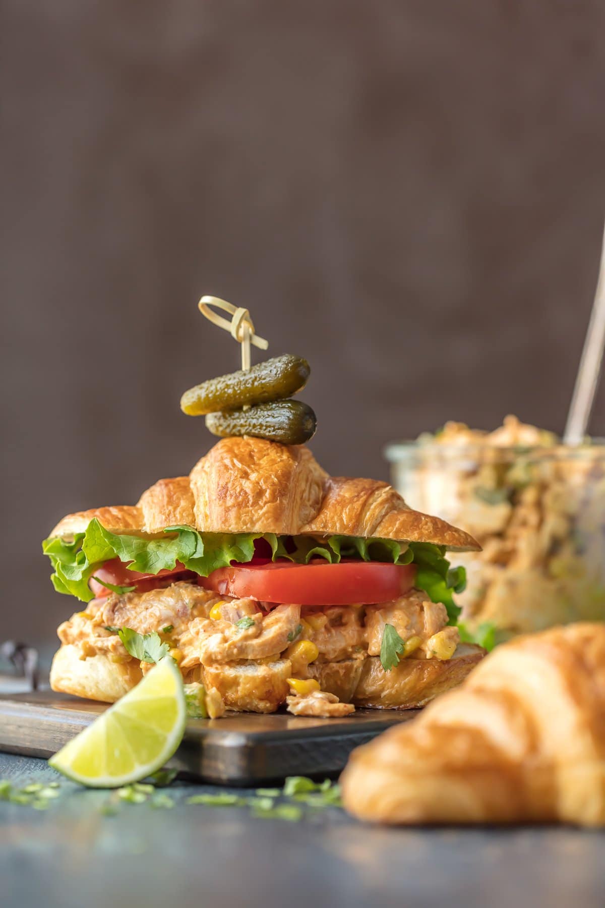 Make lunch spectacular with MEXICAN CHICKEN SALAD SANDWICHES! This easy twist on a classic is sure to please everyone at the table. Chicken salad loaded with taco seasoning, corn, peppers, and enchilada sauce. SO GOOD! Mexican Chicken Salad Sandwiches