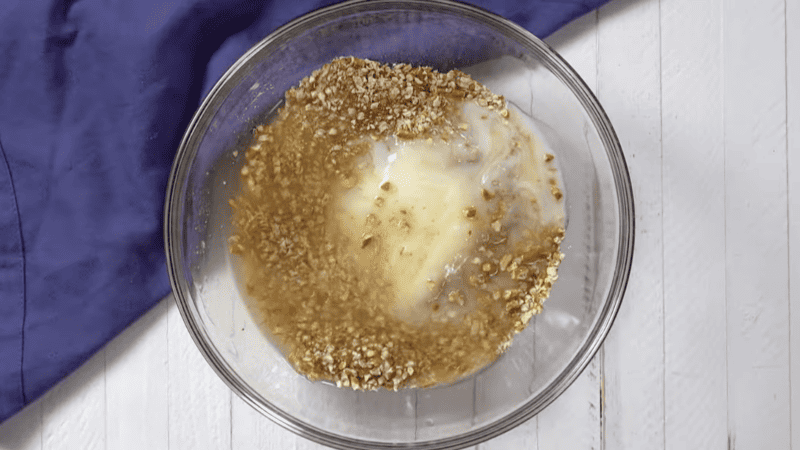 crushed pretzels, butter, and sugar in a glass bowl.