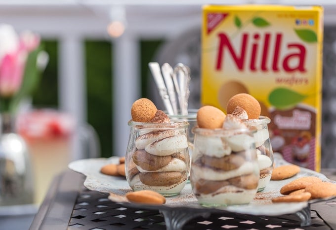 These Easy Tiramisu Cups are made with a secret ingredient, vanilla wafers! These desserts made with Nilla Wafers dipped in coffee, then layered with mascarpone mousse and topped with cocoa powder, make for the cutest mini treats, just begging to make an appearance at your next BBQ!