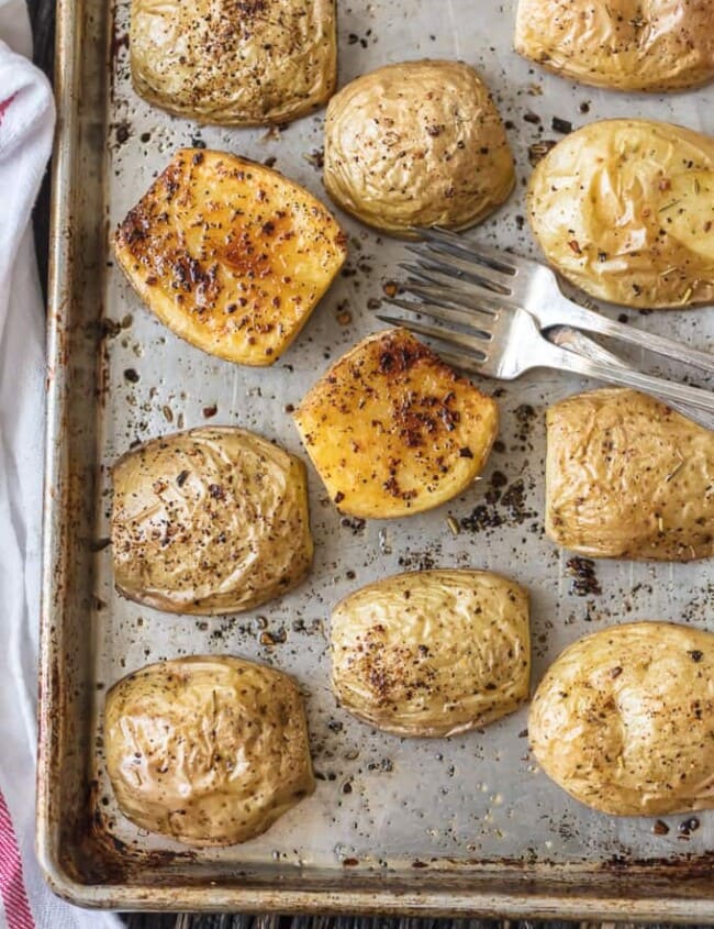 a pan of roasted potatoes with forks