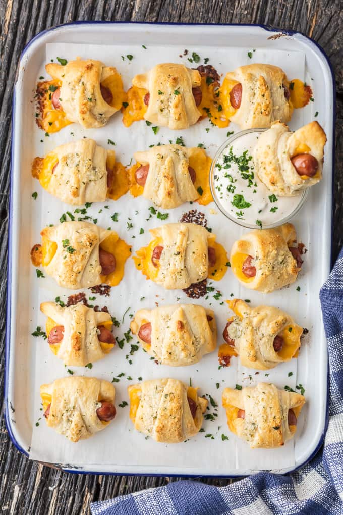 overhead shot of pigs in a blanket with cheese dipped in ranch dipping sauce