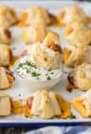 These CHEESY PIGS IN A BLANKET with RANCH PARMESAN BUTTER will be all the rage at your next party. They're easy, fun, and oh so delicious. Lil' Smokies wrapped in sharp cheddar, puff pastry, and brushed with parmesan ranch butter are sure to be a hit.