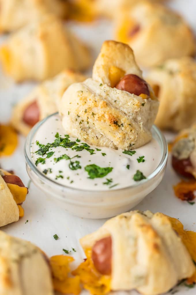 up close picture of pigs in a blanket dipping in ranch