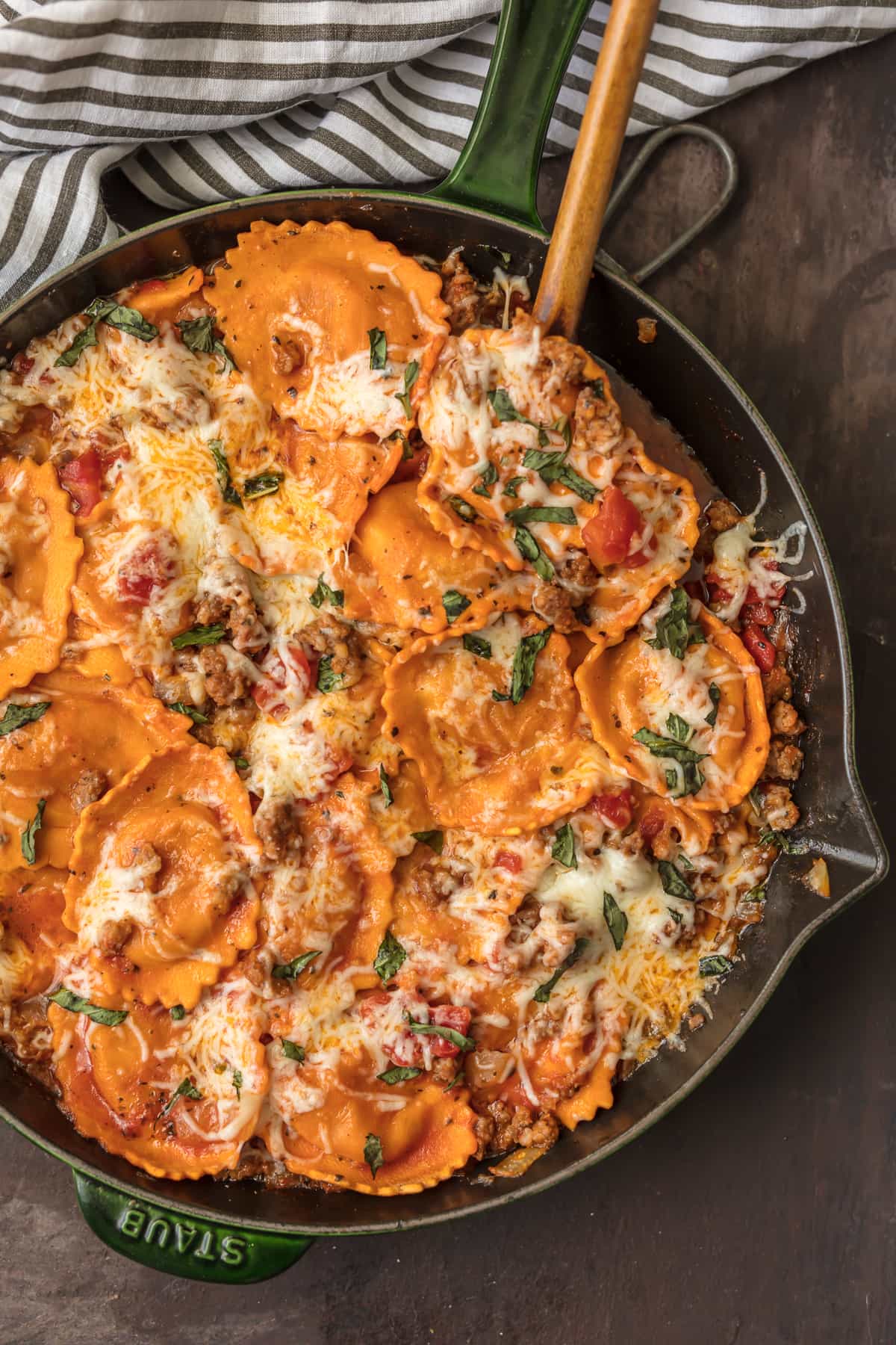 skillet filled with ravioli and Italian sausage