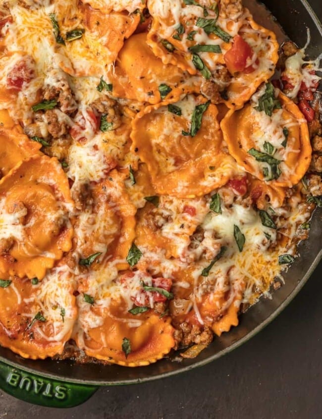 CHEESE RAVIOLI is a classic pasta dish, but I took it up a notch with this One Pan Cheese Ravioli Skillet. It's loaded with cheese-stuffed ravioli, Italian sausage, more cheese, tomatoes, and basil. It’s a simple and fun one pan dinner that everyone will ask for again and again. This cheese ravioli recipe is sure to please the entire family!