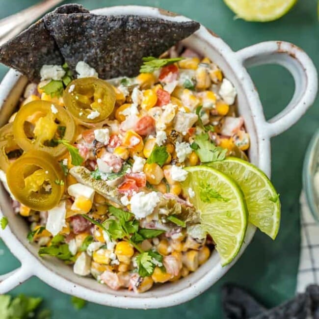 mexican street corn salsa in a bowl with blue tortilla chips