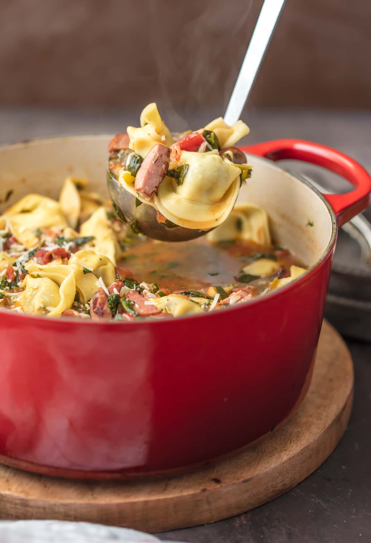 Sweet Italian Sausage Tortellini Soup in large red pot
