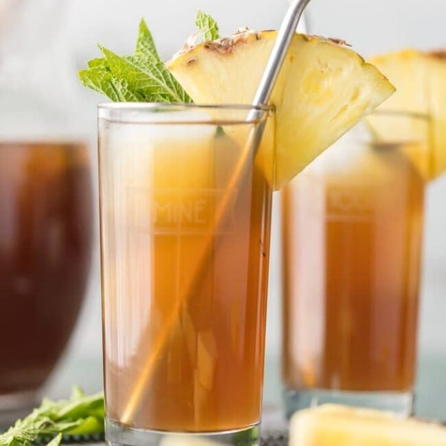 two skinny pineapple sweet teas with straws