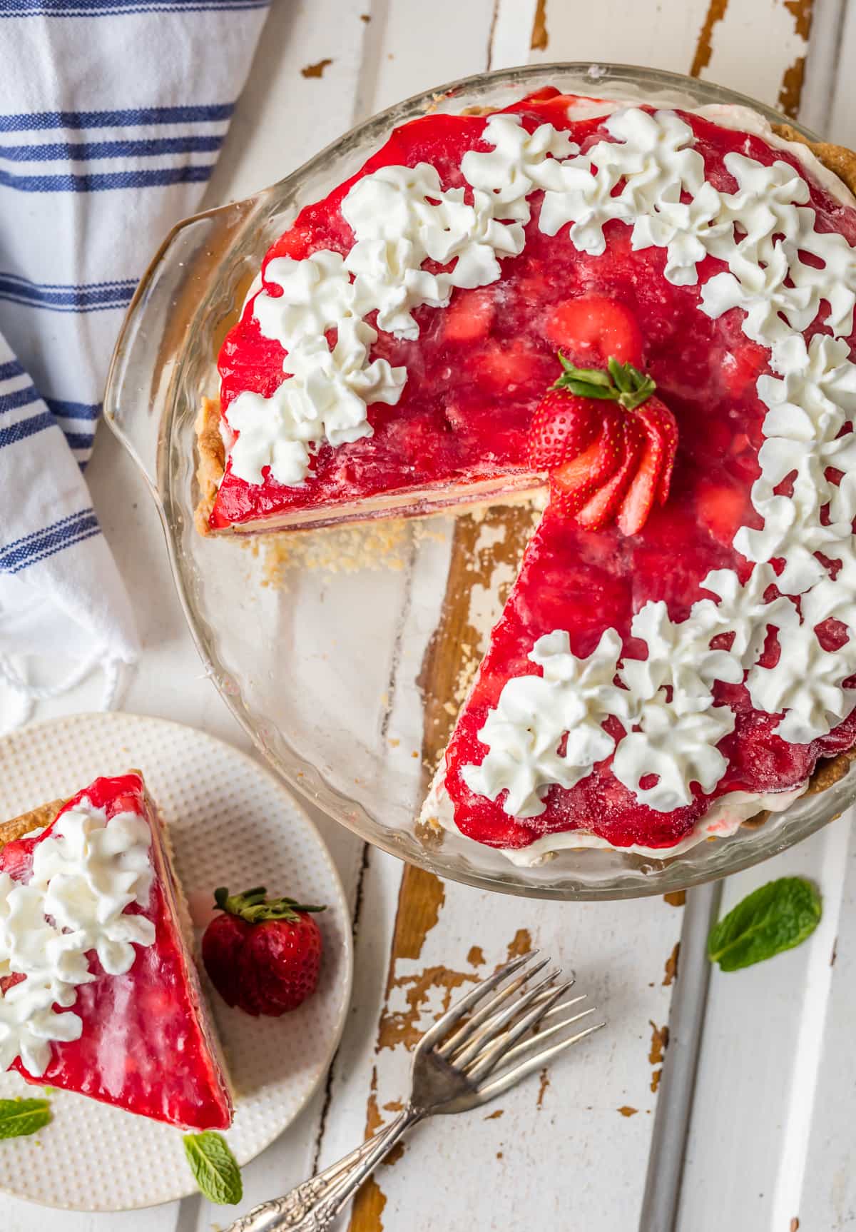 This STRAWBERRY SHORTCAKE PIE is the ultimate Summer sweet treat! Layers of strawberries, cream, and pound cake make for the most delicious (EASY) strawberry pie!