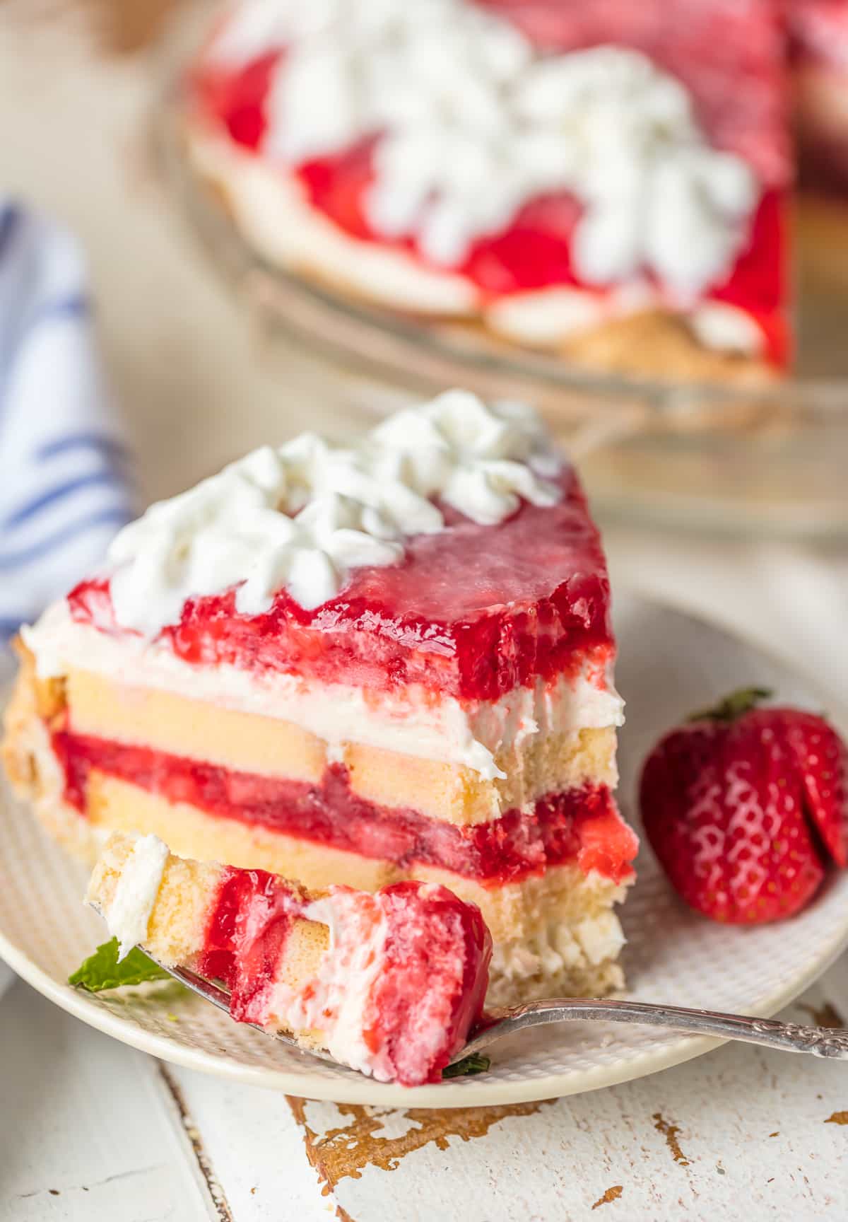 A slice of strawberry shortcake pie with a bite taken out