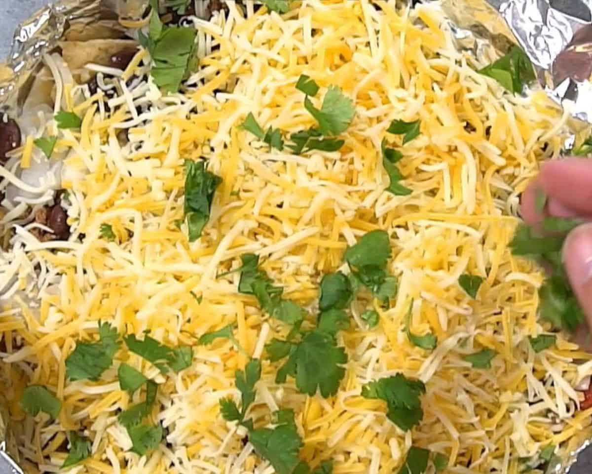 Tortilla chips covered with beef, beans, cheese, and cilantro.