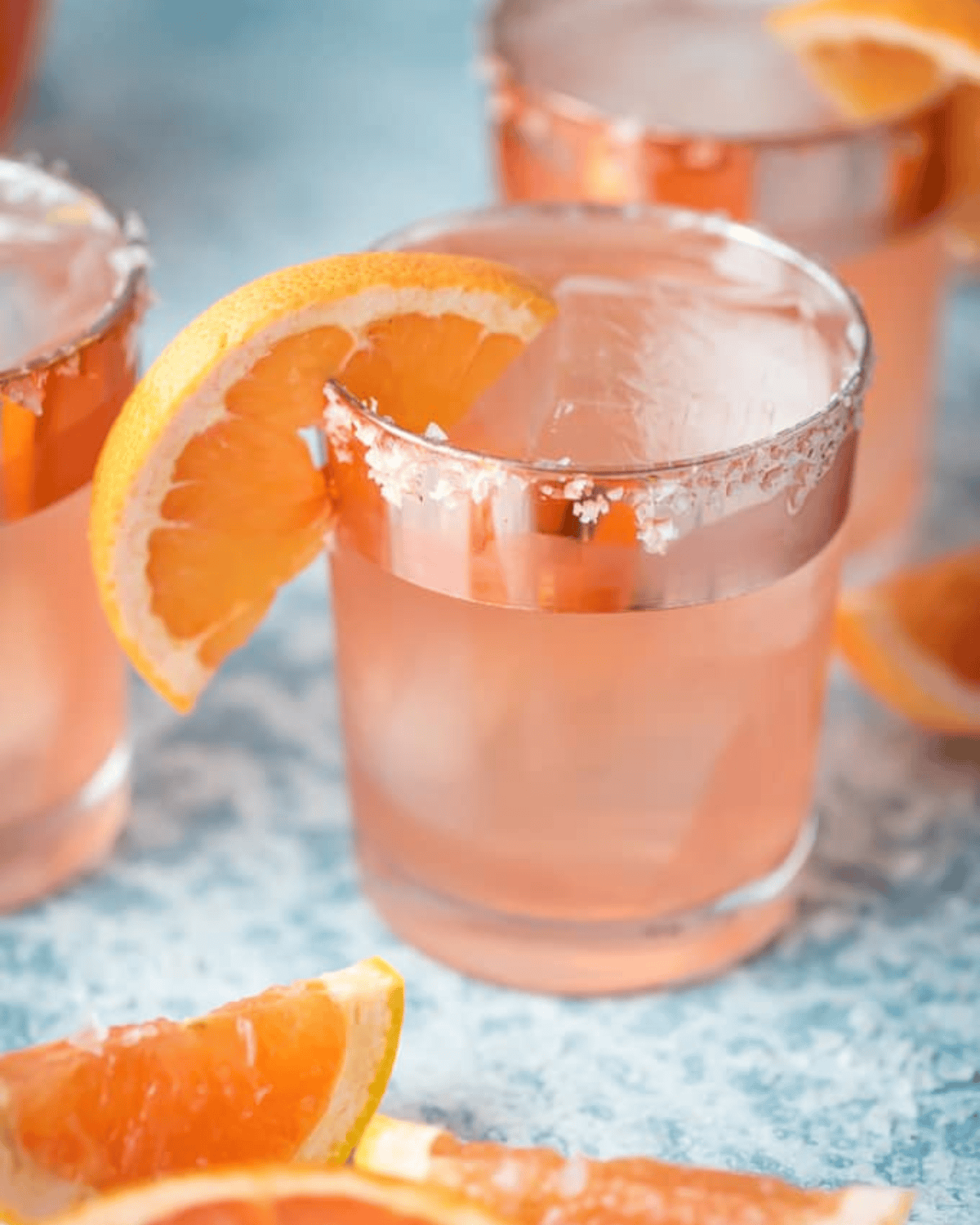 Glass of grapefruit vodka sangria garnished with a grapefruit slice.