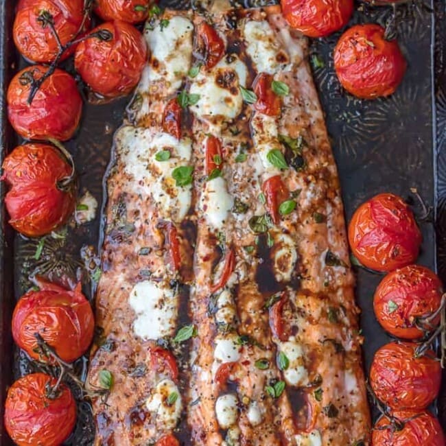 overhead shot of caprese stuffed salmon surrounded by tomatoes