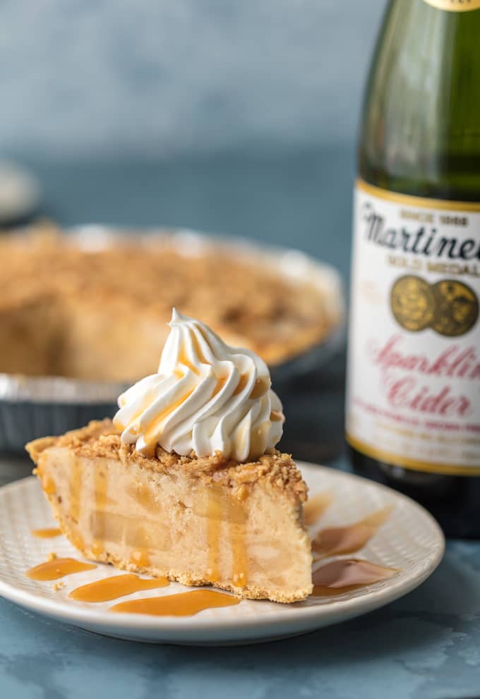 slice of pie in front of bottle of sparkling cider