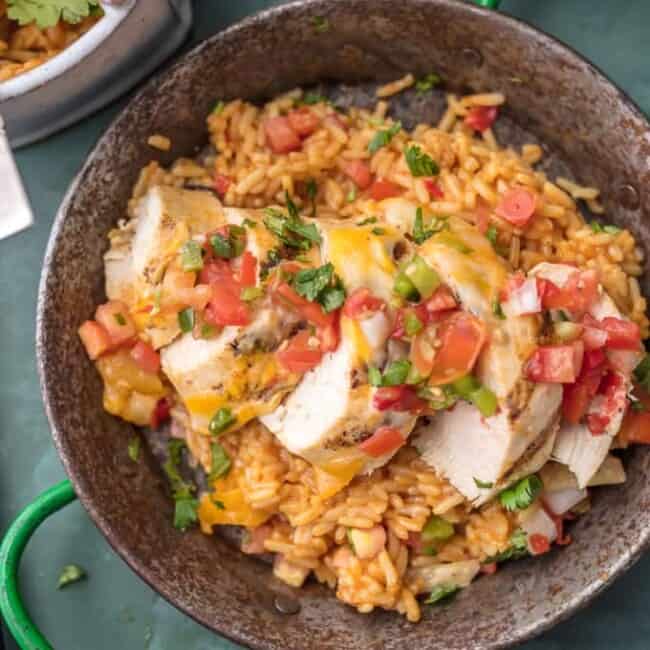 FIESTA LIME CHICKEN is our favorite easy grilled Summer meal! Served on a bed of Mexican rice and topped with lime ranch, pico de gallo, and tortilla strips; this flavor can't be beat!