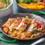 sliced fiesta lime chicken on a bed of rice on a plate