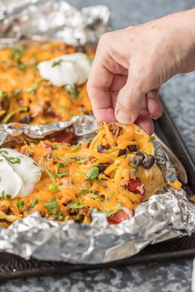 Foil Packet Recipes: Nachos topped with cheese, green chiles, beef, beans, and more