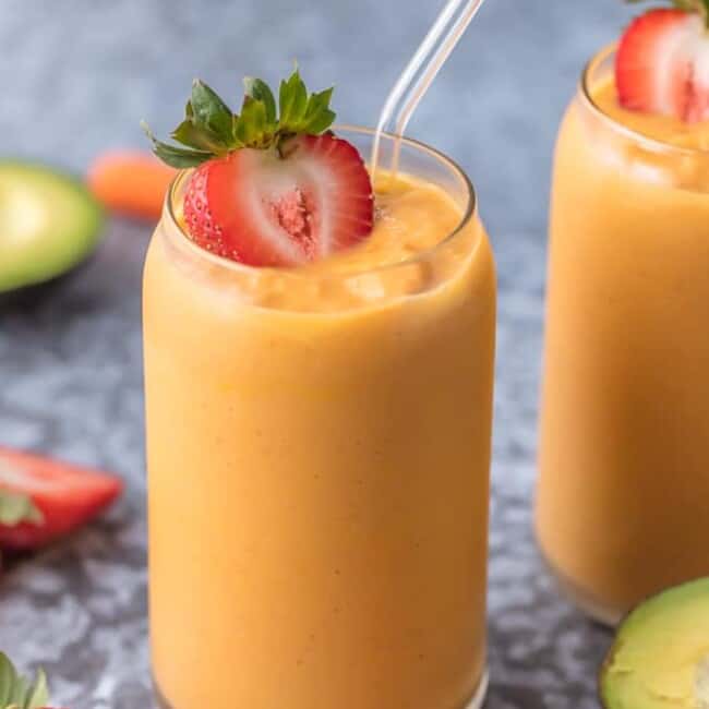 This GLOWING SKIN SMOOTHIE is full of delicious ingredients like coconut water, strawberries, mangoes, carrots, and avocado! Sip your way to beautiful skin with this easy treat.