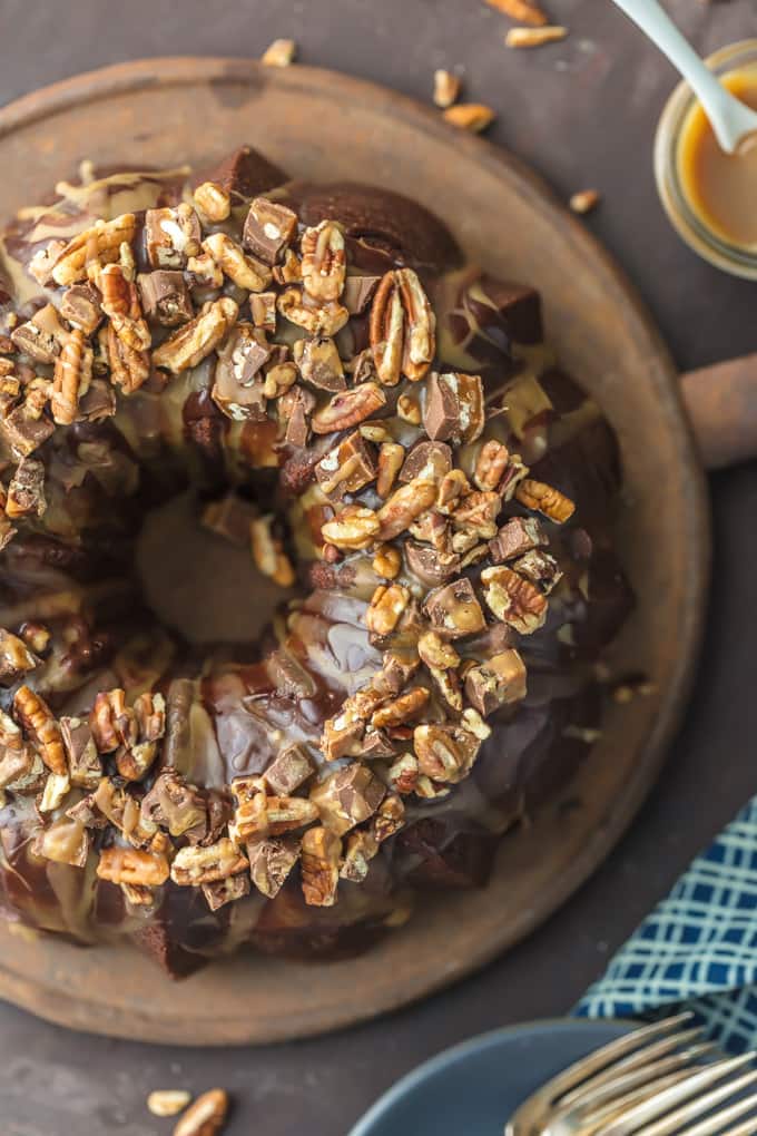 This TURTLE BROWNIE CAKE is a chocolate lovers dream. Dense and moist chocolate cake with walnuts and topped with the most incredible ganache and caramel drizzle. Crave worthy baking!