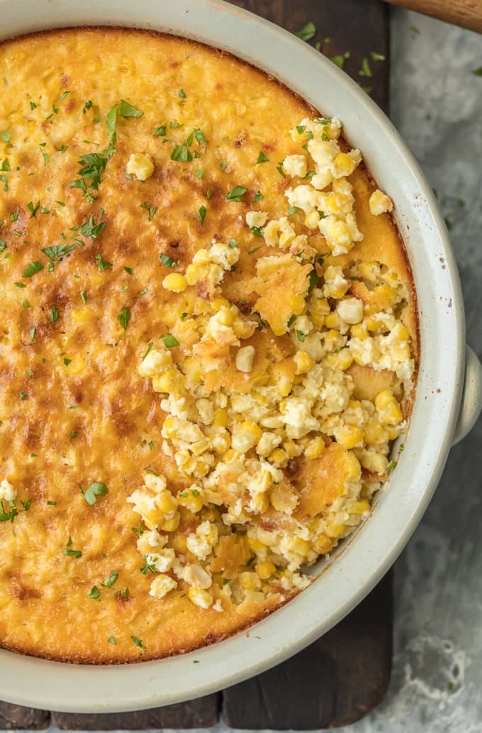 CORN PUDDING is a classic holiday side dish recipe. Your holiday table isn't complete without this easy corn pudding recipe! This delicious side dish is the perfect complement for Thanksgiving foods such as turkey and greens or Christmas favorites, especially ham. YUM! Find out how to make corn pudding with this recipe. Chunky cornbread in a casserole dish.