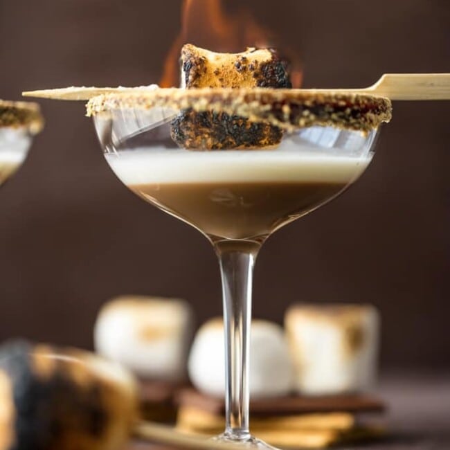 toasted smores martinis with a marshmallow on fire