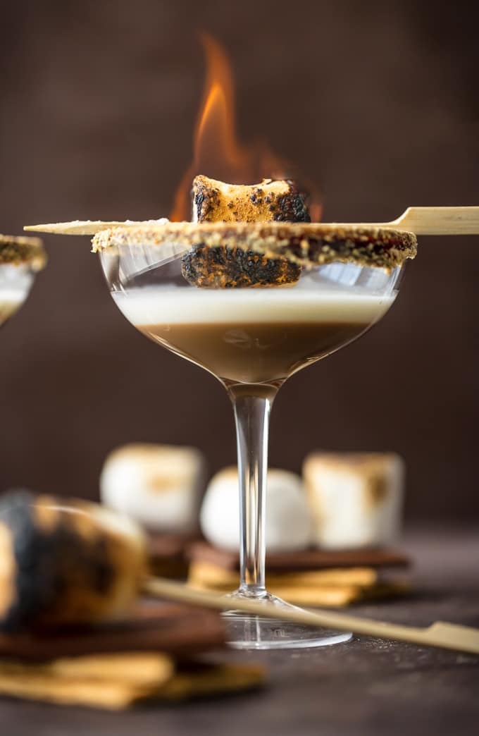 S'mores Martini i in a glass with a toasted marshmallow as garnish