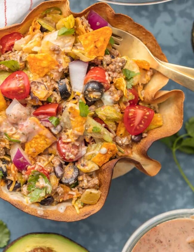 TACO SALAD is one of my favorite weeknight meals. It's simple, fresh, and easy to make. Taco Bowls are like a healthy version of my favorite Mexican dishes! We just love these CREAMY TACO SALAD BOWLS any night of the week. With a homemade tortilla bowl and loaded with all the toppings, this recipe can't be beat.