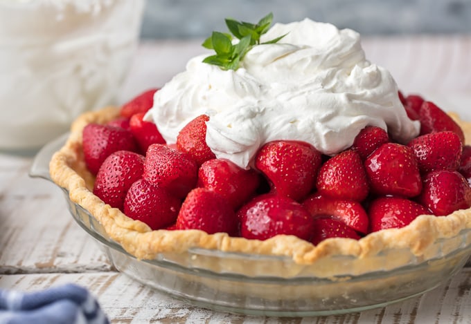 glass pie pan with strawberry pie inside of it on a table