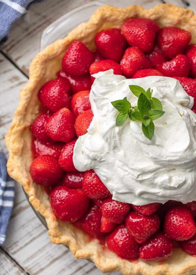 top view of fresh strawberry pie with whipped cream