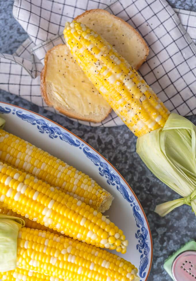 Fresh boiled corn on the cob with a lice of buttered bread