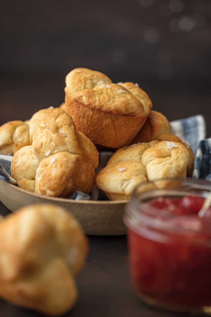 plate of rolls next to jar of jam
