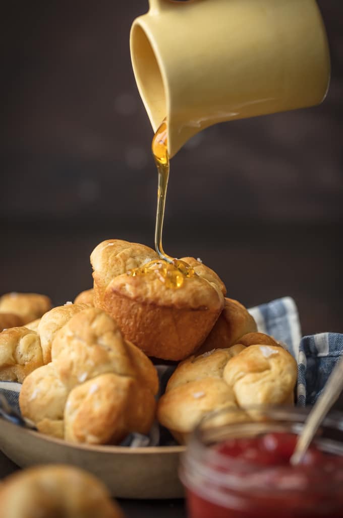 pouring honey onto rolls