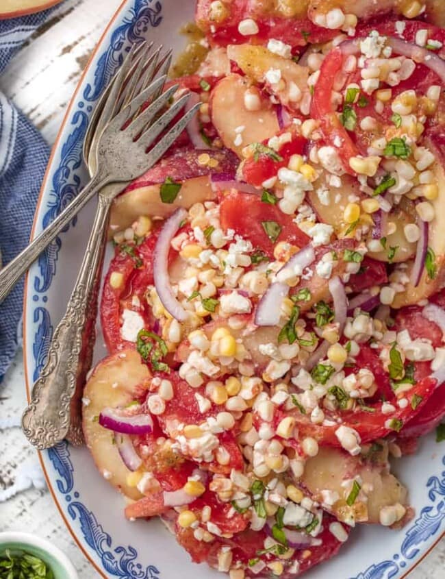 This PEACH TOMATO CORN SALAD WITH SPICY HONEY VINAIGRETTE is so fresh, delicious, and easy. Make it as a side or a meal, its delicious throughout the day. SO MUCH FLAVOR.