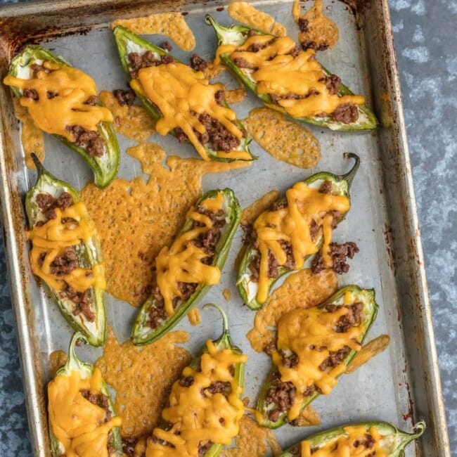 This CHEESEBURGER STUFFED JALAPENO POPPERS recipe is a fun and delicious game day appetizer! We love these spicy bites for tailgating, parties, or a tasty night spent at home.