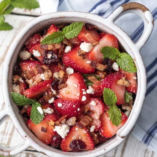 This STRAWBERRY BACON SALAD with HONEY LIME BALSAMIC VINAIGRETTE salad dressing is the perfect salad for summer. Fresh, sweet, savory, and rich, with feta, pecans, and mint on top.